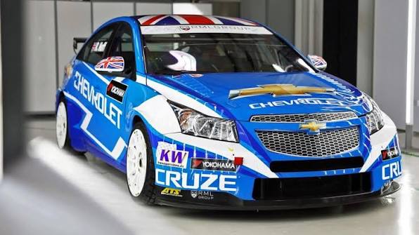 Front three-quarter view of blue Chevrolet Cruze race car in modern garage